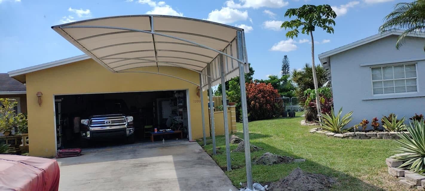 White curved canopy over a residential driveway