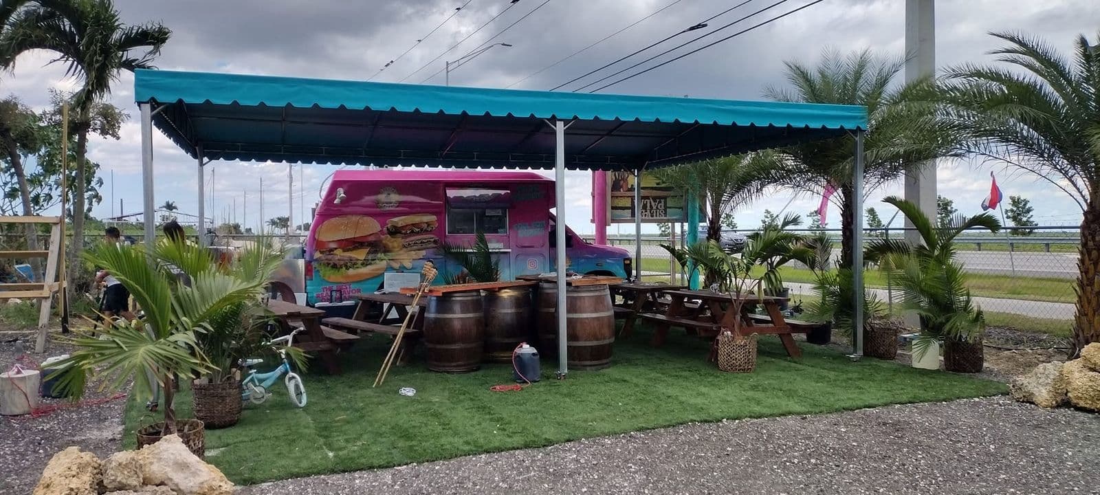 Teal canvas awning covering an outdoor dining area