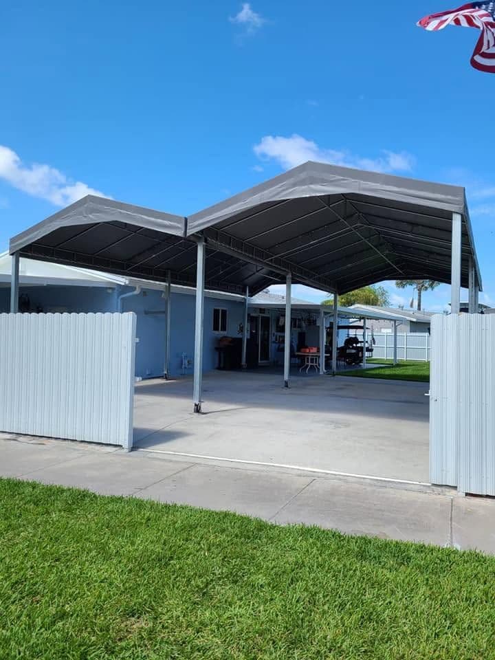 Gray carport canopy covering a residential driveway
